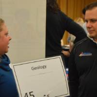 An alumnus talking to a faculty member at the Academic Major Fair.